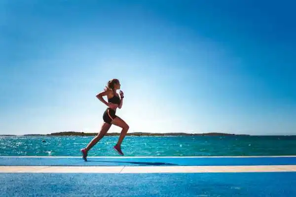 Woman running showing strong leg muscle Greenock